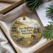 A round ornament with a picture of Fort Robinson State Park, Nebraska, featuring a horse, a wagon, and a building, hanging from a string.