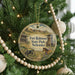 A round ornament hanging on a Christmas tree, featuring a scene from Fort Robinson State Park, Nebraska.