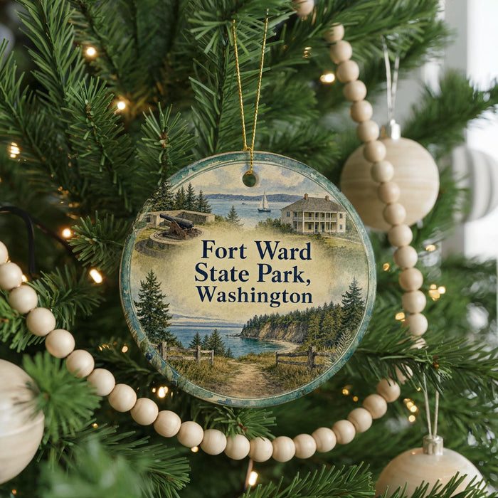 A round ornament hanging on a Christmas tree, featuring a scenic image of Fort Washington State Park in Washington, with a house and a boat in the background.