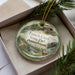 A decorative ornament in a box, featuring a scenic image of French Creek State Park in Pennsylvania.