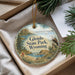 A decorative ornament with a scenic landscape of Glendo State Park, Wyoming, featuring a bird perched on a tree branch and a sailboat on the water.