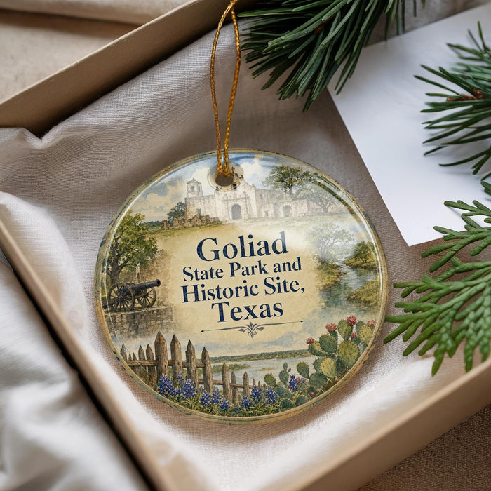 A round ornament with a picture of a historical site, specifically Golíad State Park and Historic Site, Texas, hanging from a string.