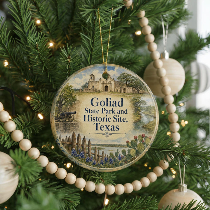 A round ornament hanging on a Christmas tree, featuring a scenic image of a historic site in Texas.