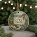 A round ornament with a scenic landscape of Gorges State Park, North Carolina, featuring a waterfall, pine trees, and a bird perched on a rock.