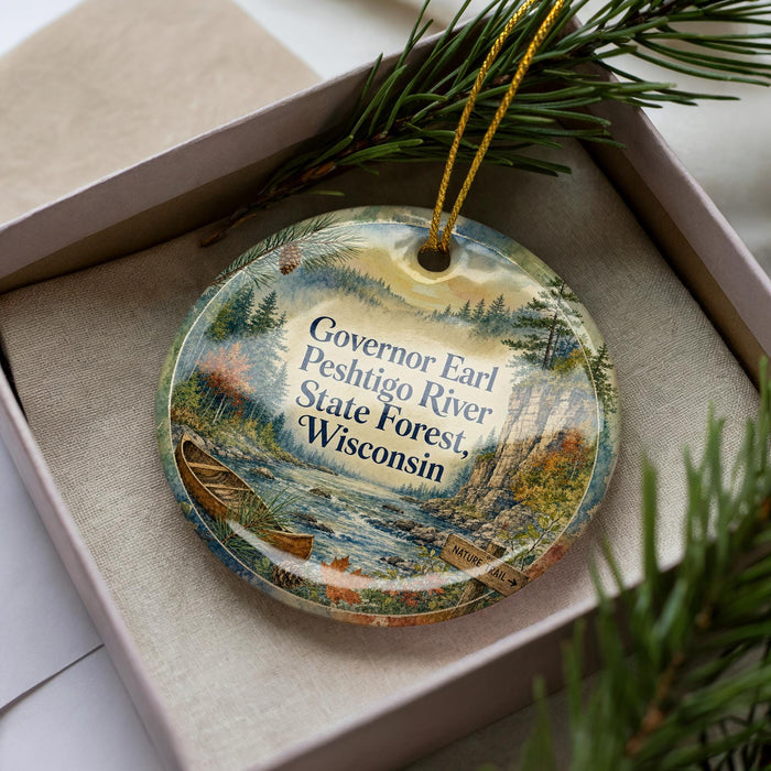 A decorative ornament in a box, featuring a scenic image of the Governor Earl Peshtigo River State Forest in Wisconsin.