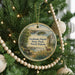 A Christmas tree decorated with ornaments, including a circular ornament with a scenic image of Grahams Island State Park in North Dakota.