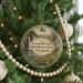 A round ornament hanging on a Christmas tree, featuring a scenic image of Granville Gulf State Reserve in Vermont.