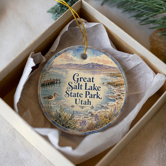 A decorative ornament in a box, featuring a scenic image of Salt Lake State Park in Utah.
