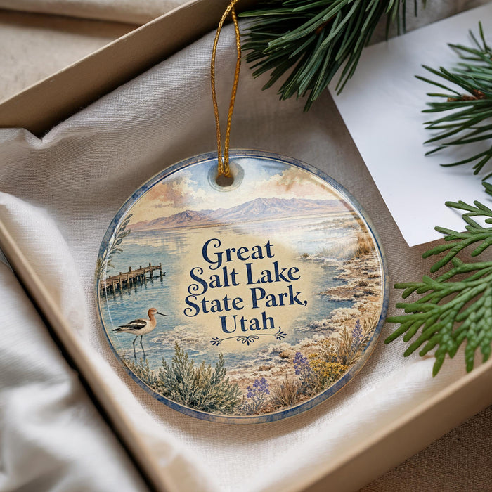 A decorative ornament with a scenic image of a lake and mountains, featuring a bird and text that says "Great Salt Lake State Park, Utah".
