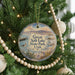 A round ornament hanging on a Christmas tree, featuring a scenic image of Salt Lake State Park in Utah.