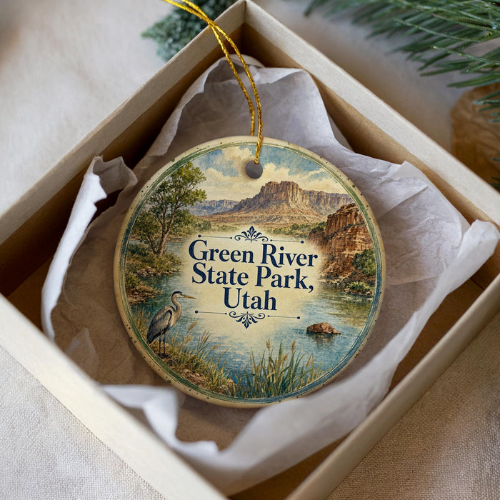 A round ornament with a scenic image of the Green River State Park in Utah, featuring a heron and a mountain landscape.