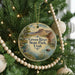 A round ornament hanging on a Christmas tree, featuring a scenic image of the Green River State Park in Utah.