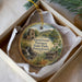 A decorative ornament in a box, featuring a scenic image of Pennsylvania's Greenwood Furnace State Park.