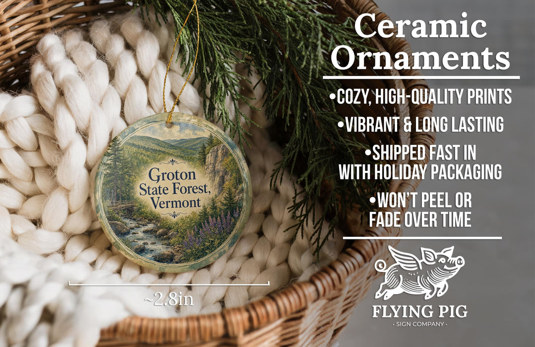 Ceramic ornaments, featuring a scenic image of the Groton State Forest in Vermont, are displayed in a woven basket.
