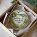 A round ornament with a scenic image of Guilford Lake State Park, Ohio, hanging from a string.