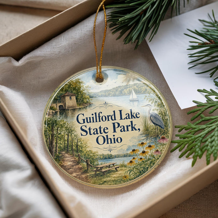 A decorative ornament with a scenic image of Guilford Lake State Park, Ohio, hanging from a string.