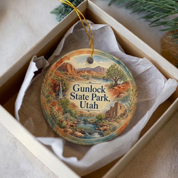 A round ornament with a scenic landscape of Gunlock State Park, Utah, displayed in a white box with a gold string.
