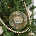 A round ornament hanging on a Christmas tree, featuring a scenic image of Ha Tonka State Park, Missouri.