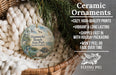 Ceramic ornaments, featuring a round ornament with a bird and palm tree design, hanging from a wicker basket.