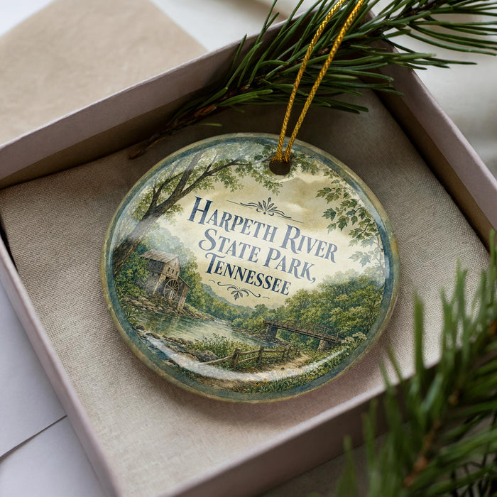 A decorative ornament in a box, featuring a scenic image of Harpeth River State Park in Tennessee.