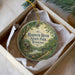 A decorative ornament in a box, featuring a scenic image of Harpeth River State Park, Tennessee.