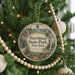 A round ornament hanging on a Christmas tree, featuring a scenic landscape of Harriman State Park in New York.