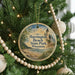 A round ornament hanging on a Christmas tree, featuring a scenic image of Harrington Beach State Park in Wisconsin.