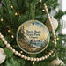 A round ornament hanging on a Christmas tree, featuring a scenic landscape of the coastal region of Oregon.