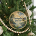 A round ornament hanging on a Christmas tree, featuring a scenic image of Harrison Bay State Park in Tennessee.