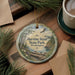 A round ornament with a scenic image of Harstine Island State Park, Washington, featuring a bird in flight, pine trees, and a river.