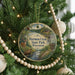 A round ornament hanging on a Christmas tree, featuring a scenic image of Hartman Creek State Park, Wisconsin.