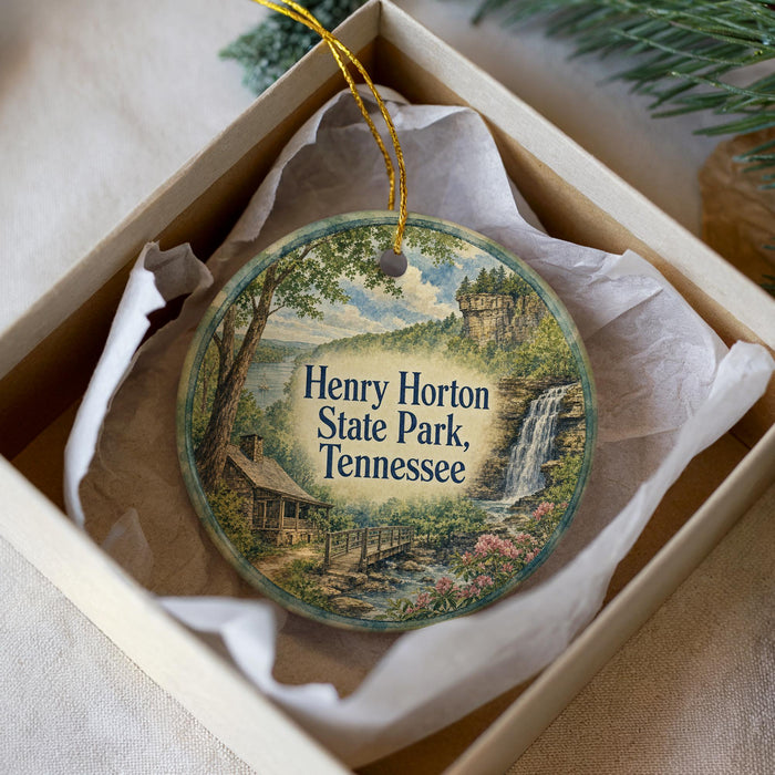 A round ornament with a scenic image of Henry Horton State Park, Tennessee, hanging from a string.