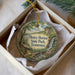 A round ornament with a scenic image of Henry Horton State Park, Tennessee, hanging from a string.