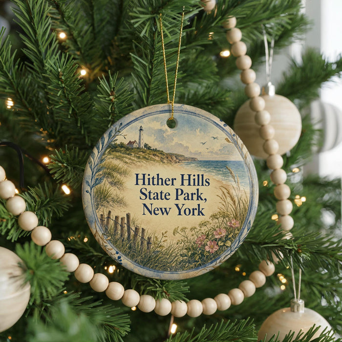 A Christmas tree decorated with ornaments, including a round ornament with a lighthouse and a beach scene, surrounded by lights and greenery.
