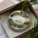 A decorative ornament featuring a scenic image of Hochtown State Park, Oklahoma, with a waterfall and a cabin in the background.
