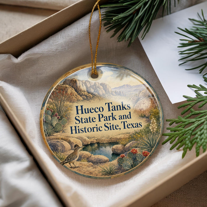 A decorative ornament with a bird and desert landscape, featuring the text "Hueco Tanks State Park and Historic Site, Texas".