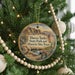 A round ornament hanging on a Christmas tree, featuring a scenic image of Hueco Tanks State Park and Historic Site, Texas.