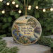 A circular ornament with a scenic landscape of Inks Lake State Park, Texas, featuring a bird, flowers, and a body of water.