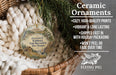 Ceramic ornaments, featuring a ceramic ornament with a landscape scene and text, hanging in a basket with pine branches.
