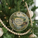 A round ornament hanging on a Christmas tree, featuring a scenic image of Jamaica State Park, Vermont.