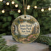 A round ornament with a scenic landscape featuring a waterfall, castle, and trees, hanging from a string.