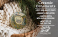 Ceramic ornaments, featuring a landscape scene with a waterfall and pine trees, are displayed in a woven basket.