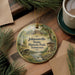 A circular ornament with a scenic illustration of Johnsonville State Historic Park in Tennessee, featuring a river, buildings, and trees.