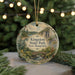 A round ornament with a scenic landscape of a mountain, river, and pine trees, featuring the text "Kingston State Park, New Hampshire".