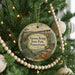 A round ornament hanging on a Christmas tree, featuring an illustration of the Kinzua Bridge in Pennsylvania.