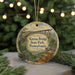A circular ornament featuring an illustration of the Kinzua Bridge in Pennsylvania, surrounded by greenery and a scenic landscape.