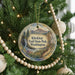 A Christmas tree decorated with ornaments, including a circular ornament with a scenic image of Klickitat Trail State Park in Washington.