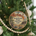 A circular ornament hanging on a Christmas tree, featuring an illustration of the Kodachrome Basin State Park in Utah.