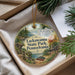 A round ornament with a scenic landscape of Lackawanna State Park, Pennsylvania, featuring a river, trees, and a cabin.