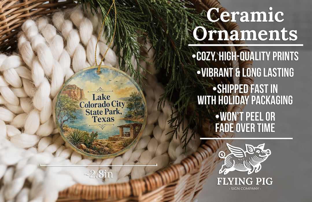 Ceramic ornaments, including a round ornament with a scenic landscape of Lake Colorado City State Park, Texas, hanging from a wicker basket.